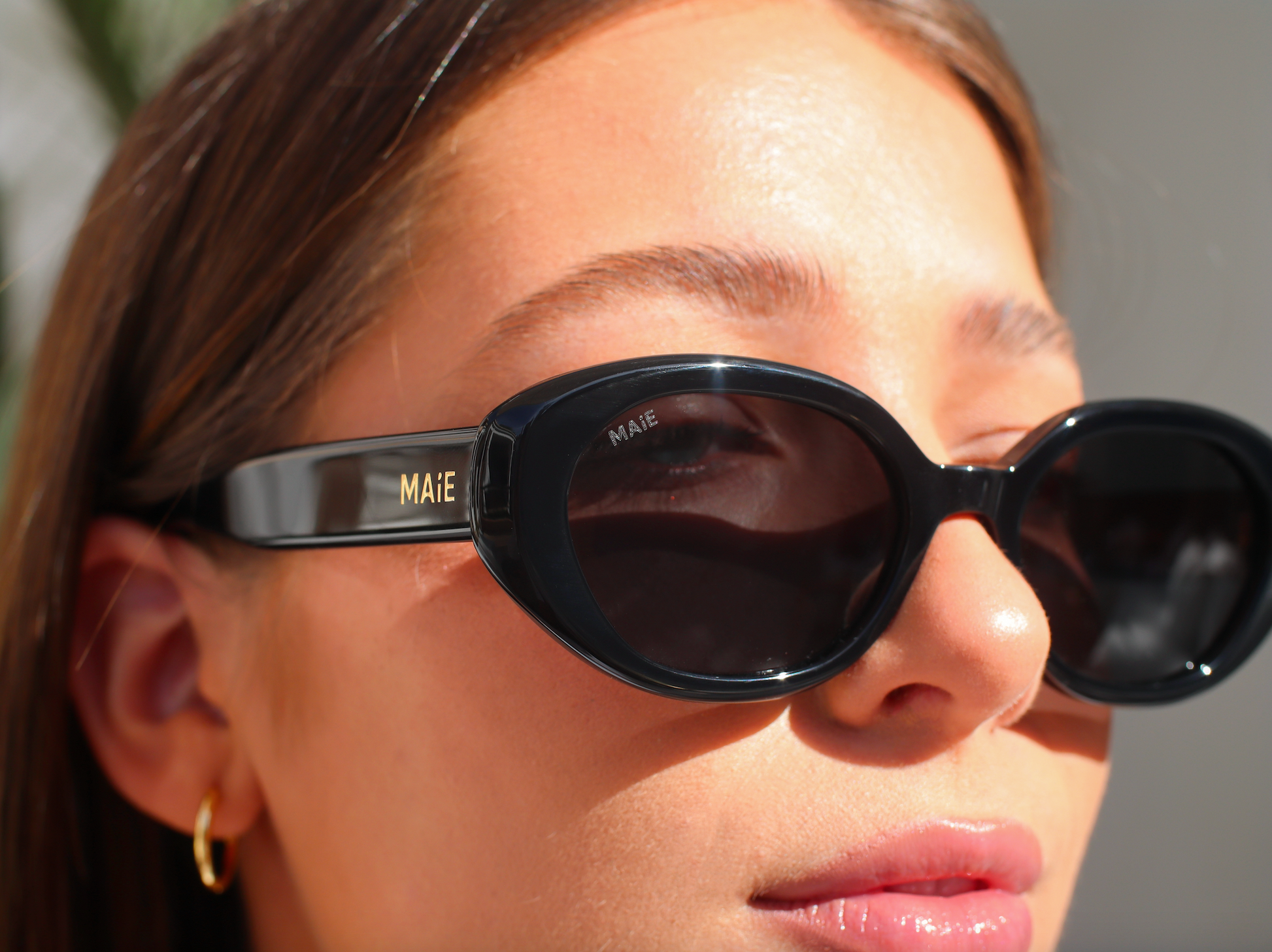 round black sunglasses gold MAIE logo 